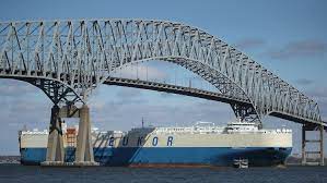 A cargo ship passes below the Francis Scott Key Bridge while leaving the Port of Baltimore October 14, 2021, in Baltimore, Maryland.